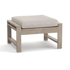 a wooden bench with a gray cushion on it