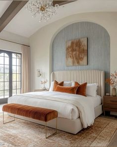 a large bed sitting in a bedroom on top of a rug next to a window