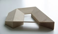 a wooden object sitting on top of a white table