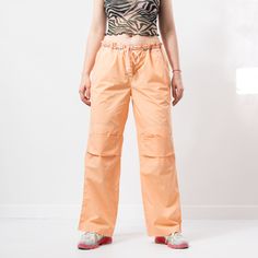 "The light track pants in orange - brand: Danza Fitness - tied waist - 2 pockets - materials: cotton SIZE size from label: XXL MEASUREMENTS waist: 40 inches (102 cm) hips: 44 inches (112 cm) rise: 10.5 inches (27 cm) length: 40.5 inches (103 cm) inseam: 30 inches (76 cm) The model is 5'9\" (174 cm), measures 35-27-38 (89-69-96 cm) and typically wears clothing in size M CONDITION - 8/10 - The pants in great pre-owned condition. Washed, ready to wear." Sporty Cotton Cargo Pants With Functional Drawstring, Sporty Cotton Cargo Pants With Drawstring, Orange Drawstring Bottoms For Loungewear, Orange Sweatpants With Pockets For Loungewear, Casual Orange Pants With Relaxed Fit, Orange Cotton Sweatpants With Pockets, Casual Peach Wide Leg Bottoms, Casual Orange Sweatpants For Sports, Orange Cotton Sports Bottoms