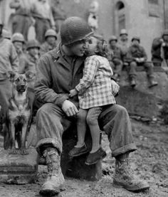 an old black and white photo of a man holding a small child in his lap