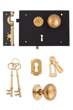 an assortment of antique brass door knobs and keys