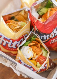 three different types of tacos and chips on a tray