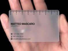 a person's hand holding a business card in front of a ruler that says mateo mascaro