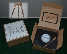 an open box with a golf ball in it