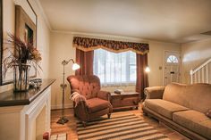 a living room filled with furniture next to a window