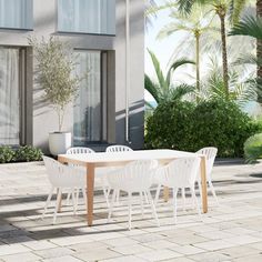 a white table and chairs sitting on top of a brick patio