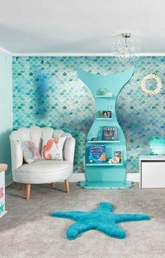 a living room filled with furniture and a blue starfish wallpaper on the wall