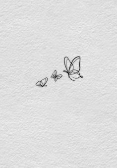 two butterflies flying over each other on a white paper background with the word love written in black ink