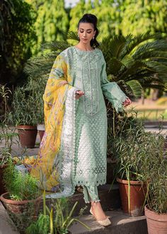 Mint Green Pakistani Dress in Salwar Kameez Style is an elegant masterpiece that gives you your desired dreamy appearance on a festive occasion. Embroidery work and lavish designs on this beautiful Salwar Kameez make it an exquisite choice for the big day. Kameez: The mint-colored kameez comes in textured organza fabric. Beautiful embroidery work and floral designs give a mesmerizing look to the kameez. The kameez is paired with a cotton silk slip. Intricate designs and fine details make this ka Elegant Green Churidar With Chikankari Embroidery, Elegant Designer Pista Green Churidar, Designer Chikankari Embroidery Dress For Diwali, Designer Dresses With Chikankari Embroidery For Diwali, Green Dress With Chikankari Embroidery In Traditional Drape, Diwali Designer Dresses With Chikankari Embroidery, Green Dress With Chikankari Embroidery, Traditional Drape, Eid Dresses With Intricate Embroidery In Straight Kurta Style, Straight Kurta Dress With Intricate Embroidery For Eid