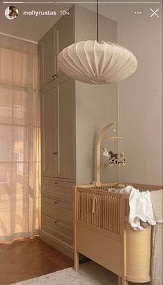 a baby's room with a crib and dresser