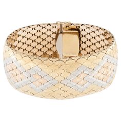 The Art Deco Iconic Cuff-Bracelet is a breathtaking piece crafted with precision and elegance. Made from 18kt Yellow, White and Rose Gold, this cuff exudes luxury and sophistication. The honeycomb design adds a touch of geometric allure, creating a visually striking pattern that captivates the eye. The bracelet features meticulous flower carvings, showcasing intricate details that contribute to its overall charm. The artisan's skill is evident in the precision of these floral motifs, adding a touch of nature-inspired beauty to the piece. A satin finish lends a smooth and velvety texture to the surface, enhancing the tactile experience of wearing this exquisite cuff. The bracelet features a stylized honeycomb technique. The honeycomb motif became popular in the 1930s through bracelet design Van Cleef & Arpels, Flower Carving, Honeycomb Design, Victorian Gold, Gold Bracelet Cuff, Gold Cuffs, Van Cleef Arpels, Bracelet Designs, Floral Motif