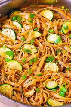 a pan filled with noodles, zucchini and sauce