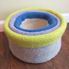 a close up of a cat bed on a wooden floor