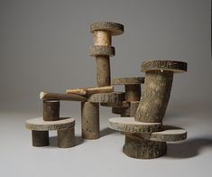 several pieces of wood sitting on top of each other in front of a gray background