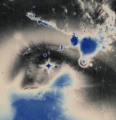 an image of a woman's eye with blue and white bubbles in the background