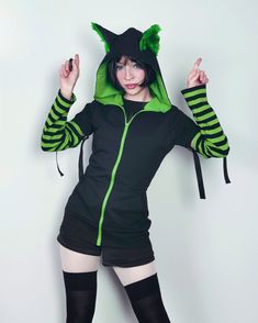 "𝘾𝘼𝙏 𝙀𝘼𝙍𝙎 𝙃𝙊𝙊𝘿𝙄𝙀 - 𝙂𝙍𝙀𝙀𝙉 - 𝙈𝘼𝙇𝙀 / 𝙁𝙀𝙈𝘼𝙇𝙀 𝘾𝙐𝙏 Black cat hoodie with ears. This cat ear hoodie has green fur inside the standing cat ears. 𝗪𝗛𝗔𝗧 𝗪𝗜𝗟𝗟 𝗜 𝗥𝗘𝗖𝗘𝗜𝗩𝗘？ ♥ Zip up hoodie ♥ Hood with cat ears (fur inside) ♥ Detachable sleeves (easy to apply!) ♥ Sleeves with thumbholes ♥ Big pockets to hold your stuff :D 𝗙𝗔𝗕𝗥𝗜𝗖: Cotton sweatshirt, faux fur for the ears 𝗦𝗜𝗭𝗘: Male or female cut. Size chart you will find it on the last photo! For custom si Casual Halloween Cosplay Hoodie, Fitted Casual Hoodie For Halloween, Casual Fitted Hoodie For Halloween, Green Stretch Cotton Hoodie, Fitted Long Sleeve Punk Hoodie, Fitted Long Sleeve Halloween Hoodie, Green Stretch Top With Drawstring Hood, Fitted Alternative Long Sleeve Hoodie, Fitted Long Sleeve Alternative Style Hoodie