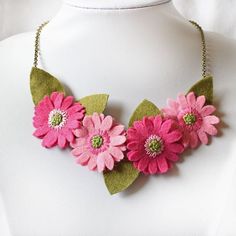 This pink necklace & earrings jewellery set will inject colour and fun into your Summer wardrobe, This gorgeous set is made from hand cut and hand embroidered felt gerberas in pretty pink shades of pink. These vibrant felt flowers are great wedding accessories and a sheer delight to add to your holiday suitcase! They colourful flowers on the necklace, hang from  antique gold coloured chain with a trigger clasp. A butterfly charm hangs by the clasp to complete this unique floral jewellery. The ea Handmade Pink Flower Necklace Gift, Elegant Pink Necklace With Handmade Flowers, Pink Handmade Adjustable Flower Necklace, Handmade Adjustable Pink Flower Necklace, Holiday Suitcase, Felt Flower Necklace, Handmade Pink Flower-shaped Necklace, Felt Decor, African Daisy