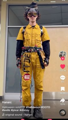 a man in yellow jumpsuits and goggles standing next to an airport door