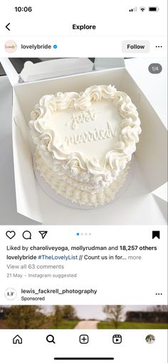 a cake in a box with the words love is surrounded by white frosting on it