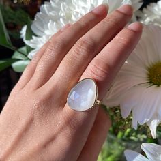 Calling all pearl lovers! This large white moonstone cocktail ring is set in 925 Sterling silver with a thick and lasting gold plating. This natural moonstone has a soft, iridescent feel to it, white still shining a beautiful pearly tone. Casual, stunning, stackable! In the photo with the three rings, the white moonstone is pictured on the middle finger. White Moonstone 925 Sterling silver Vermeil gold plating (2.5 micron) Elegant White Teardrop Moonstone Ring, White Moonstone Pearl Ring Gift, Elegant Moonstone Ring With Large Stone For Wedding, Anniversary Moonstone Ring With Large Stone, White Moonstone Rings With Large Stone, White Moonstone Ring With Large Stone, White Large Stone Moonstone Ring For Anniversary, White Moonstone Ring With Large Stone For Anniversary, White Moonstone Ring