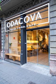 the storefront of an italian restaurant called odaccova, with its glass doors open