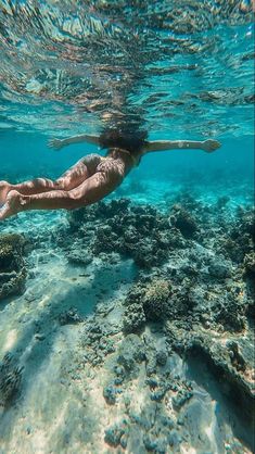 a woman is swimming in the ocean