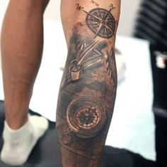 a man with a compass tattoo on his leg