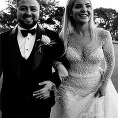 a man in a tuxedo standing next to a woman wearing a dress with sequins