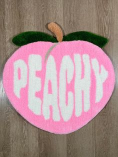 a pink and white door mat with the word peachy on it