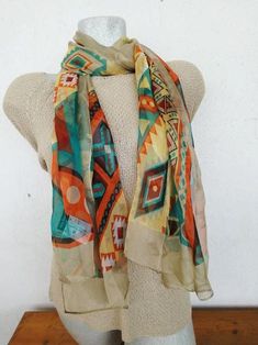 Vintage polyester scarf in colourful, ethnic patterns is a long rectangular scarf in green, orange, yellow, etc.It's also got black and brown and turquoise and white among the other colours.Its main colour and background fro the other colours is an earthy, ecru, dark beige.This is a lovely, southwestern patterns shawl, made before 2000 in PRC (China).The brand is Julia Bergovich, a European brand or womenswear. This multi colour, gorgeous, long scarf is 100% polyester.Its background is all ecru Southwestern Patterns, Elegant Scarves, Polyester Scarf, Ethnic Patterns, Long Scarf, Lovely Colors, Green Orange, Style Icon, Orange Yellow