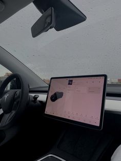 an ipad is sitting on the dashboard of a car