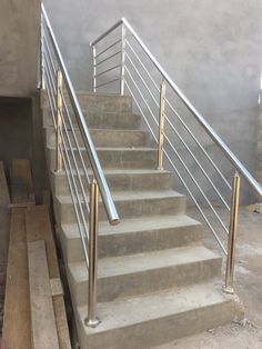 there is a set of stairs with handrails next to the concrete flooring