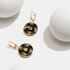 Thes beautiful black onyx circle earrings are crafted in choice of rhodium or 18K yellow gold plated sterling silver. The black onyx stones are known for their grounding and protective properties, making them a great choice for everyday wear. The high polished plating adds a luxurious touch to the sterling silver setting, making these earrings a timeless piece. The leverback closure ensures a secure fit, making them a comfortable and stylish choice. | Aurealis Black Onyx Circle Leverback Earring Elegant Enamel Jewelry, Luxury Round Pierced Earrings, 14k Gold Round Earrings For Evening, Elegant 14k Gold Jewelry With Black Enamel, Luxury Black Jewelry, Evening 14k Gold Jewelry With Black Enamel, Yellow Gold Round Jewelry For Evening, Luxury Round Earrings For Evening, Black Pierced Earrings In Fine Jewelry Style