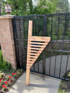 a wooden stair case in front of a gate