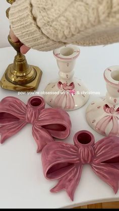 pink bows and candlesticks on a white table