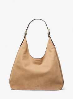 The Nolita hobo bag looks relaxed yet refined in supple nubuck with structured edges that define its shape. It features an adjustable shoulder strap with polished buckles and a large open interior for stashing everything you need.