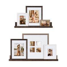 three wooden frames with pictures hanging on the wall