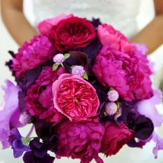 a bridal bouquet with pink and purple flowers