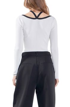 Slender ribbing shapes this top with a strappy neck design made from chic contrast trim. Split neck with crossover straps Long sleeves 60% rayon, 30% nylon, 10% polyester Hand wash, line dry Imported Chic Tops With Contrast Collar, Elegant White Top With Contrast Collar, Fitted Top With Contrast Collar For Spring, Elegant Fitted Tops With Contrast Trim, Elegant Tops With Contrast Trim For Work, Cross Neck, Contrast Trim, Neck Designs, Long Sleeve Top