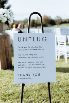 a sign that says unplug on it in front of some chairs and tables