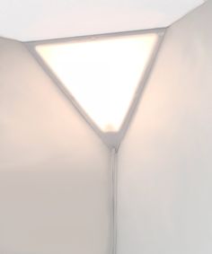 a white room with a light on the ceiling