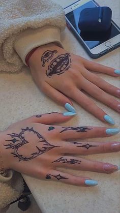 a woman's hand with tattoos on it