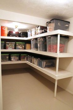 an organized pantry with plastic containers and bins on shelving units in the corner