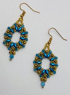 These elegant earrings are handmade and feature gold and teal bead with a little teal drop. Gold Beaded Earrings With Spacer Beads, Elegant Gold Beaded Earrings With Spacer Beads, Gold Teardrop Earrings With Spacer Beads, Blue Earrings With Gold Beads, Elegant Turquoise Beaded Earrings With Gold Beads, Gold Dangle Earrings With Peacock Design, Teal Beaded Earrings, Turquoise Earrings With Gold Beads For Gift, Elegant Turquoise Earrings With Gold Beads