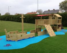 a wooden pirate ship playset with slide and climbing frame in the grass next to a child's play area