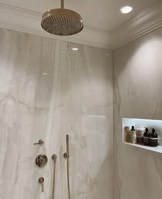 the shower head is mounted on the wall above the bathtub