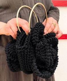 The black crochet bag is a handcrafted yet elegant piece, perfect for completing a casual or boho-chic look. Made from hand-woven cotton or natural fiber yarns, this bag stands out for its unique texture and intricate patterns created by the crochet technique. The black color gives it a timeless sophistication while adding a touch of modernity to its traditional design. It often features sturdy handles and a convenient closure, offering both style and functionality to carry your essentials in st Black Bohemian Crochet Bag Handwoven, Black Macrame Crochet Bag For Everyday Use, Black Handwoven Crochet Bag For Daily Use, Black Bohemian Crochet Bag For Everyday, Black Woven Crochet Tote Bag, Black Handmade Bohemian Crochet Bag, Black Crochet Bag Hand Knitted For Everyday Use, Chic Handmade Crochet Bag For Everyday Use, Black Hand-knitted Crochet Bag For Daily Use