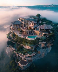 an aerial view of a house surrounded by fog