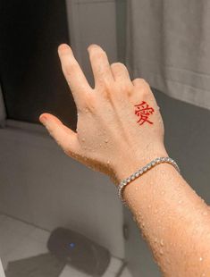 a woman's hand with red writing on it